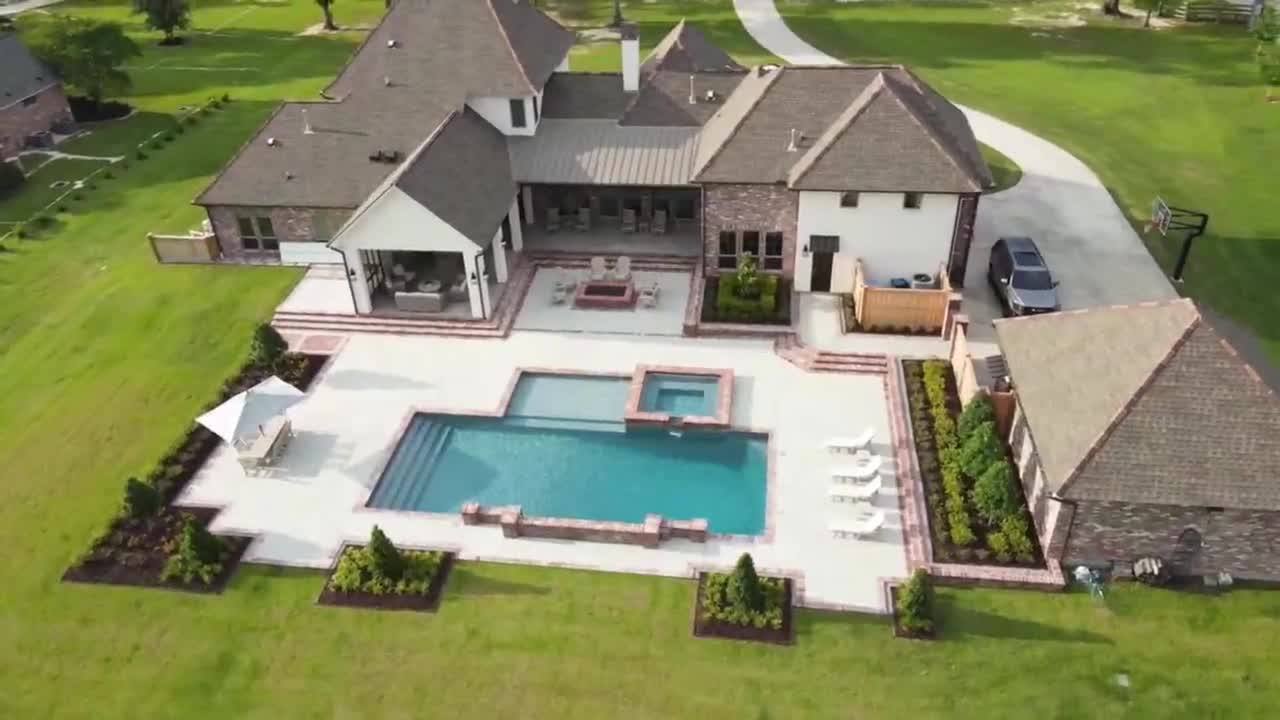 Aerial still from Blue Wave Pools’ published hero film — custom pool builder in Baton Rouge